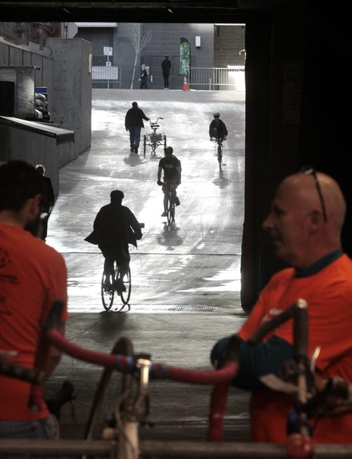 Cyclists arrive and depart the MTS Centre for the free breakfast to kick off Bike Week 2014. Volunteers (foreground) were checking in bikes for cyclists. Wayne Glowacki / Winnipeg Free Press June 16 2014