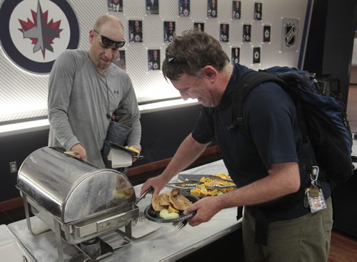 At right, cyclists Brad De Ryck and Trevor Oltsher in the MTS Centre for the free breakfast to kick off Bike Week 2014 Monday morning.Wayne Glowacki / Winnipeg Free Press June 16 2014