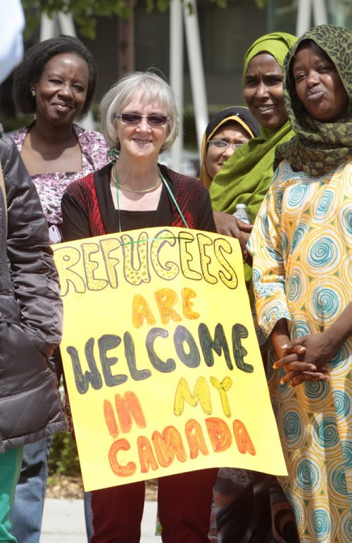 In centre, Karen Giesbrecht along with about a hundred people took part in the Walk with Refugees for a Stronger Canada. The walk was a guided tour highlighting significant places and stories for refugees, former refugees and others seeking protection in our city. The walk returned to Central Park for a rally in support of services for and protection of refugees. Carol Sanders story Wayne Glowacki/Winnipeg Free Press June 16 2014