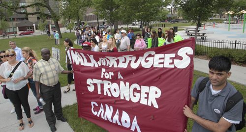 About a hundred took part in the Walk with Refugees for a Stronger Canada. the walk was a guided tour highlighting significant places and stories for refugees, former refugees and others seeking protection in our city. The walk returned to Central Park for a rally in support of services for and protection of refugees. Carol Sanders story Wayne Glowacki/Winnipeg Free Press June 16 2014