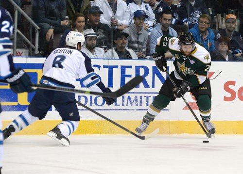 Texas Stars player Travis Morin carries the puck into the St. John's Ice Caps zone during first period AHL action at Mile One Centre. At left is Ice Caps player Brenden Kichton.  Photo by Keith Gosse/The Telegram