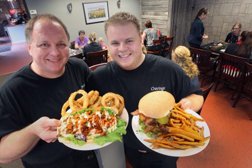 Cravings-266 4th Street East, Stonewall, MB, Canada- son Chris Wawryk, right with Double Deluxe burger with sweet potato fries- and dad Randy with Spicy crispy PoBoy chicken sandwich - See Marion Warhaft review- June 17, 2014   (JOE BRYKSA / WINNIPEG FREE PRESS)