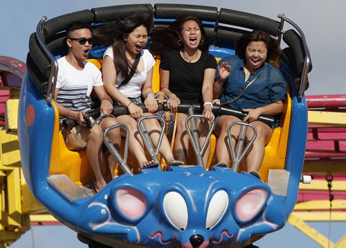June 17, 2014 - 140617  -  (L to R) Ace Martin Prieto, Norlyn Brual, Cynthia Berces and Naldine Reyes on Crazy Mouse at The Ex Tuesday, June 17, 2014. John Woods / Winnipeg Free Press