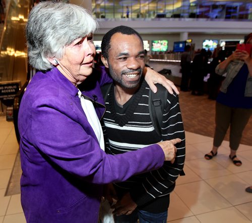Quesney Ramazani and Phyllis Reader embrace he arrived in Winnipeg Wednesday evening. See Alex Paul story. June 18, 2014 - (Phil Hossack / Winnipeg Free Press)