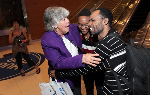 Phyllis Reader embraces Quesney Ramazani and his son Didier (15) as they arrived in Winnipeg Wednesday evening. See Alex Paul story. June 18, 2014 - (Phil Hossack / Winnipeg Free Press)