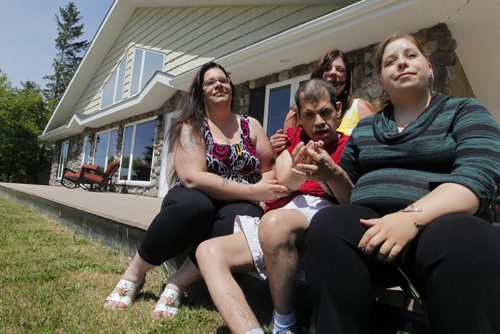 PHILANTHROPY - for Kevin Rollason story. (L-R) Residential support worker Carrie Howell, Karen Palsson, acting executive director of Riverdale Place Homes, residential support worker Anna Boundy, with front centre resident Neil Krate, 47. The home is for adults with intellectual disabilities in Arborg, Manitoba. BORIS MINKEVICH / WINNIPEG FREE PRESS  June 18, 2014