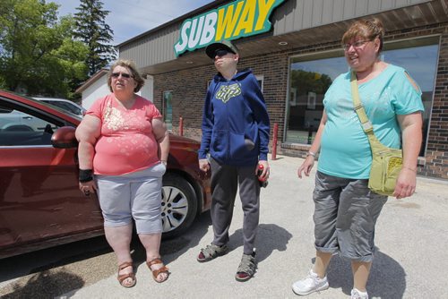 PHILANTHROPY - for Kevin Rollason story. (L-R) Riverdale Place Homes residential support worker Donna Votour on an outing with residents Perry and Laureen. They were out in the community on an outing. The homes is for adults with intellectual disabilities in Arborg, Manitoba. BORIS MINKEVICH / WINNIPEG FREE PRESS  June 18, 2014