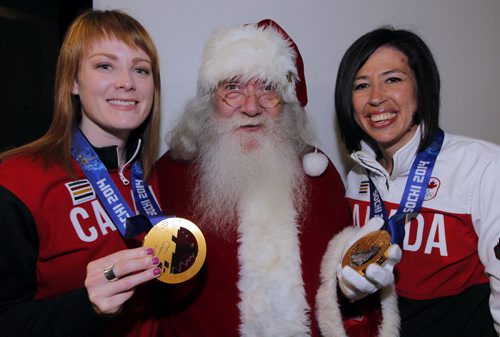 The honorary Grand Marshal is for the upcoming 2014 Winnipeg Santa Claus Parade scheduled for Saturday November 15 is team Jones, gold medal curling winners. In photo is Dawn McEwen, Santa, and Jill Officer. BORIS MINKEVICH / WINNIPEG FREE PRESS  June 19, 2014