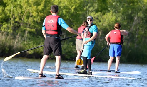 Instructor Brad Friesen (in hat) leads a WAVpaddling stand-up paddle-boarding lesson at the FortWhyte Alive Adventure Site in Winnipeg, Man., on Wed., June 18, 2014. Photo by Jason Halstead/Winnipeg Free Press RE: Intersection feature