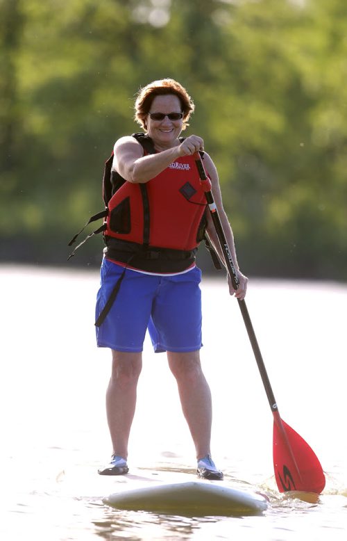 Barb Smith takes part in a WAVpaddling stand-up paddle-boarding lesson at the FortWhyte Alive Adventure Site in Winnipeg, Man., on Wed., June 18, 2014. Photo by Jason Halstead/Winnipeg Free Press RE: Intersection feature
