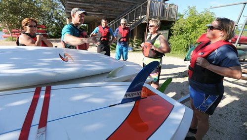 Brad Friesen of WAVpaddling (second left) works with his stand-up paddle-boarding students at the FortWhyte Alive Adventure Site in Winnipeg, Man., on Wed., June 18, 2014. Photo by Jason Halstead/Winnipeg Free Press RE: Intersection feature