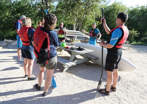 Brad Friesen of WAVpaddling (second right) works with his stand-up paddle-boarding students at the FortWhyte Alive Adventure Site in Winnipeg, Man., on Wed., June 18, 2014. Photo by Jason Halstead/Winnipeg Free Press RE: Intersection feature