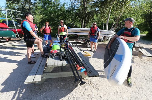 Brad Friesen of WAVpaddling (right) works with his stand-up paddle-boarding students at the FortWhyte Alive Adventure Site in Winnipeg, Man., on Wed., June 18, 2014. Photo by Jason Halstead/Winnipeg Free Press RE: Intersection feature