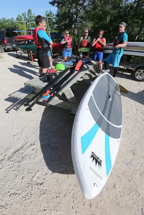 Brad Friesen of WAVpaddling (right) works with his stand-up paddle-boarding students at the FortWhyte Alive Adventure Site in Winnipeg, Man., on Wed., June 18, 2014. Photo by Jason Halstead/Winnipeg Free Press RE: Intersection feature