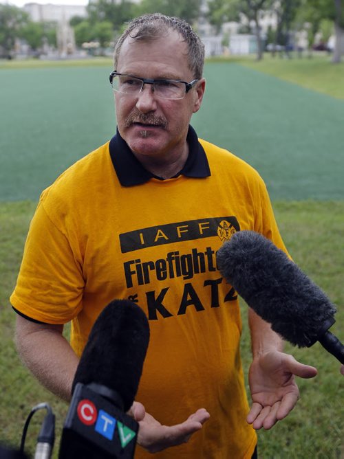 Alex Forrest President, United Firefighters of Winnipeg a sam Katz supporter wearing Katz TShirt  comments on the decsion -  Mayor Sam Katz announces he will not run for another term as mayor of the city of Winnipeg  at a Central Park  scrum.  June 20 2014 / KEN GIGLIOTTI / WINNIPEG FREE PRESS