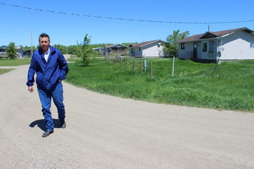 635 - 637 Chief Vince Tacan walks along a residential street in Sioux Valley Dakota Nation. BILL REDEKOP/WINNIPEG FREE PRESS June 13,2014