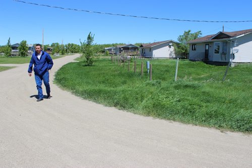 635 - 637 Chief Vince Tacan walks along a residential street in Sioux Valley Dakota Nation. BILL REDEKOP/WINNIPEG FREE PRESS June 13,2014