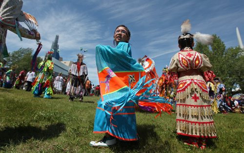 Six-year-old Daelyn Prince dances on the fields at the Forks National Historic site for Aboriginal Day Pow Wow Saturday afternoon during the Grand Entry. Standup photo.  June 21, 2014 Ruth Bonneville / Winnipeg Free Press
