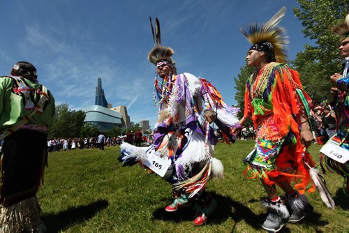 Aboriginal Dancers perform during Pow Wow on the  fields at the Forks National Historic site for Aboriginal Day Saturday afternoon during the Grand Entry. Standup photo.  June 21, 2014 Ruth Bonneville / Winnipeg Free Press