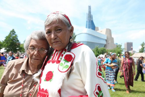 Gloria Chocan (right) and her sister Rosalie Chokin of Onion Lake Cree Nation attend the Pow Wow on the  fields at the Forks National Historic site for Aboriginal Day Saturday afternoon.  Gloria Chocan along with 10 other older Cree women are trying to get Ottawa to notice the issues facing their people by travelling from Ottawa to their reservation in Alberta.] See story.  June 21, 2014 Ruth Bonneville / Winnipeg Free Press