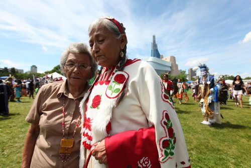 Gloria Chocan (right) and her sister Rosalie Chokin of Onion Lake Cree Nation attend the Pow Wow on the  fields at the Forks National Historic site for Aboriginal Day Saturday afternoon.  Gloria Chocan along with 10 other older Cree women are trying to get Ottawa to notice the issues facing their people by travelling from Ottawa to their reservation in Alberta.] See story.  June 21, 2014 Ruth Bonneville / Winnipeg Free Press