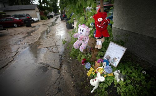 A makeshift memorial erected by the neighborhood sits where the 3 yr old son of Robert Scherban was killed in a lane between Victor and Young Streets Sunday afternoon. See story.  June 23, 2014 - (Phil Hossack / Winnipeg Free Press)