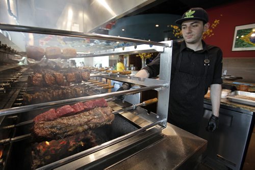 June 23, 2014 - 140623  -  Estaban Sepulveda cooks on the churrascaria bbq during a visit to Carnaval Brazilian BBQ on the Little South America Exchange District Food Tour  Monday, June 23, 2014. John Woods / Winnipeg Free Press