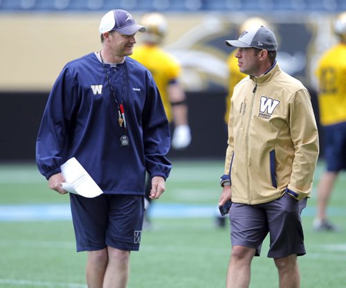 WINNIPEG BLUE BOMBER PRACTICE - Head coach Mike O'Shea and General Manager Kyle Walters chat on the field. BORIS MINKEVICH / WINNIPEG FREE PRESS  June 24, 2014