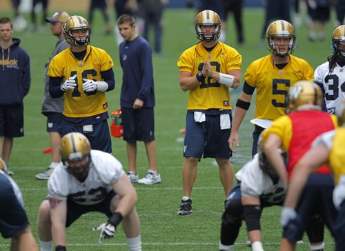 WINNIPEG BLUE BOMBER PRACTICE - QBs #16 Robert Marve, #12 Brian Brohm, and #5 Drew Willy during some drills in practice. BORIS MINKEVICH / WINNIPEG FREE PRESS  June 24, 2014