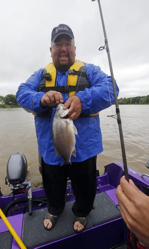 Raising awareness  first person Fish Story by Oliver Sachgau , trying to catch fish on the Red River near Selkirk . In pic guide Dan Goulet  with fish caught by and fellow fisher Mike  Morgado  June 24 2014 / KEN GIGLIOTTI / WINNIPEG FREE PRESS