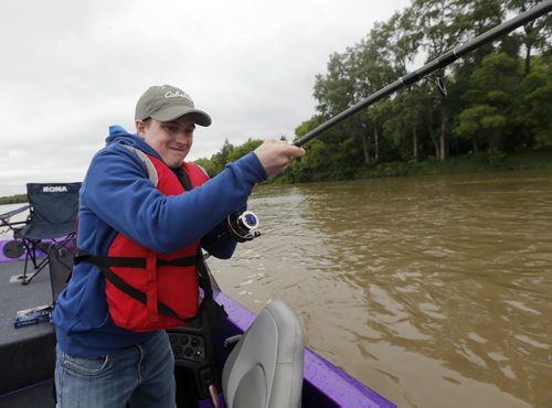 Oliver hooks a big cat fish but it breaks the line-Raising awareness  first person Fish Story by Oliver Sachgau , trying to catch fish on the Red River near Selkirk . Guide dan Goulet and fellow fisher Mike  Morgado  June 24 2014 / KEN GIGLIOTTI / WINNIPEG FREE PRESS