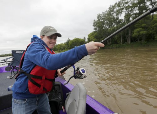 Oliver hooks a big cat fish but it braks the line- Raising awareness  first person Fish Story by Oliver Sachgau , trying to catch fish on the Red River near Selkirk . Guide dan Goulet and fellow fisher Mike  Morgado  June 24 2014 / KEN GIGLIOTTI / WINNIPEG FREE PRESS