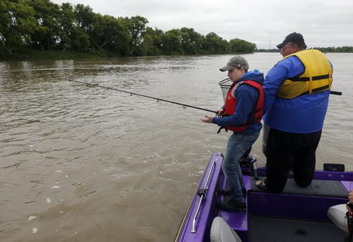 Raising awareness  first person Fish Story by Oliver Sachgau , trying to catch fish on the Red River near Selkirk . with Guide dan Goulet   June 24 2014 / KEN GIGLIOTTI / WINNIPEG FREE PRESS