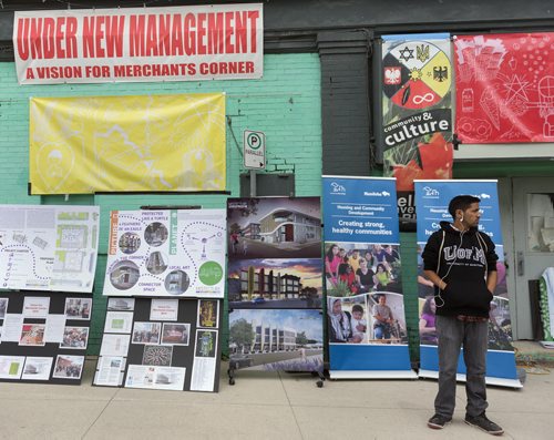 Romando Nilles with Aboriginal Youth Opportunities next to the designs for the redevelopment of the Merchant Hotel. Sarah Taylor / Winnipeg Free Press