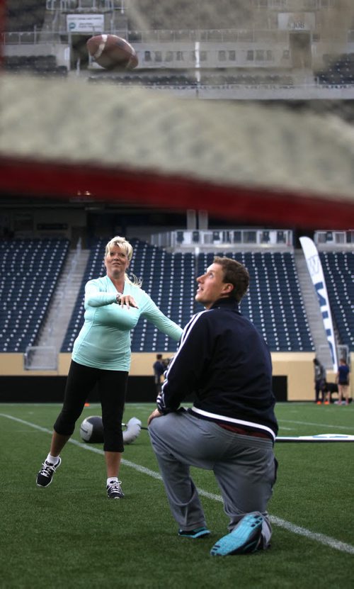 Bomber Quarter Back Drew Willie watches a pass hurled over his head by Keri Robinson Monday evening at a women's skill clinic. See Melissa's story. June 23, 2014 - (Phil Hossack / Winnipeg Free Press)