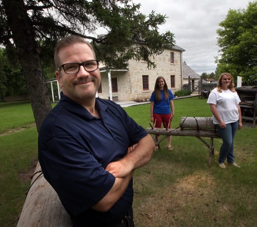 Russ Garvie poses outside the St. Andrews museum which has moved into a building that's like a museum itself, the former St. Andrews Rectory. With him are interpreters Jessica Crellin (center) and Kassidy Johnson (right). See Bill Redekop's story.  June 24, 2014 - (Phil Hossack / Winnipeg Free Press)