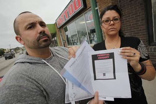 June 24, 2014 - 140624  -  Photographed outside Phase II Tattoo Tuesday, June 24, 2014 Darcy Jeanson and Cheryl Radcliffe are upset that without their permission Phase II pierced their 16 year old daughter's belly button at their booth at The Ex. John Woods / Winnipeg Free Press