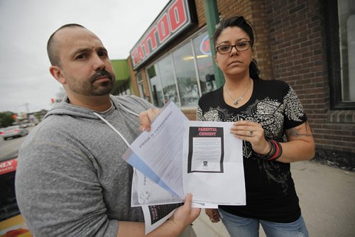 June 24, 2014 - 140624  -  Photographed outside Phase II Tattoo Tuesday, June 24, 2014 Darcy Jeanson and Cheryl Radcliffe are upset that without their permission Phase II pierced their 16 year old daughter's belly button at their booth at The Ex. John Woods / Winnipeg Free Press