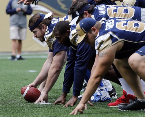Injured Centre Steve Morley rejoins offence (furthest left snapping ball  ) will be back in the lineup vs. Toronto Blue Bomber media practice  in preparation for their home game Vs Toronto on Thursday June 25 2014 / KEN GIGLIOTTI / WINNIPEG FREE PRESS