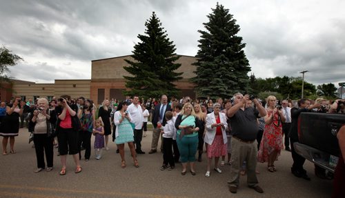 Carberry's parents gather to photograph their grads on Church Steps used as risers for the class picture Wednesday. THe Carberry Lavich quads were part of the  graduation photo on Carberry's main street. See Randy Turner's tale. June 25, 2015 - (Phil Hossack / Winnipeg Free Press)
