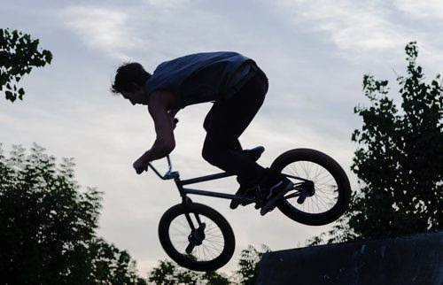 Brent Scharf jumps a ramp on his bike at the Forks Wednesday night. Sarah Taylor / Winnipeg Free Press