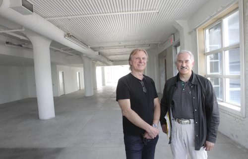 At left, Nestor Budyk, the building owner and Robert Antymniuk,  executive vice president Avison Young real estate in the available commercial space on the second floor at 448 Hargrave St.  Budyk owns the building and has spent years and tens of thousands of dollars converting it into an office/condo complex. Anymniuk is the Avison Young real estate agent who is trying to find tenants for the bottom two floors of office space. (The top three floors are condo units).Murray McNeill story Wayne Glowacki / Winnipeg Free Press June 26 2014