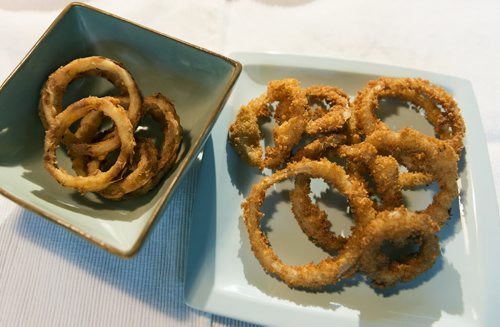 Traditional onion rings in the green bowl and crispy onion rings with panko on the blue plate. Sarah Taylor / Winnipeg Free Press