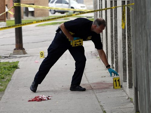 Police investigators place evidence markers along Kennedy S. , the incident began at Cumberland  and Kennedy St progressing south  to ending at 461 Kennedy . Wpg Police investigate a crime scene  on Cumberland Ave . between at Balmoral St.  ans Edmonton ST. , three women were stabbed , all are in stable . June 27 2014 / KEN GIGLIOTTI / WINNIPEG FREE PRESS