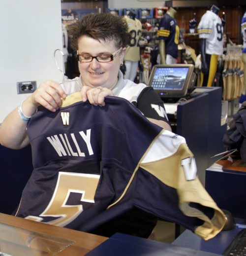 Bomber Store Manager Maria Todd prepares to ring up another Winnipeg Blue Bomber QB Drew Willy #5 jersey sale Friday, the day after the season opener victory over Toronto.   Paul Wicek story Wayne Glowacki / Winnipeg Free Press June 27 2014