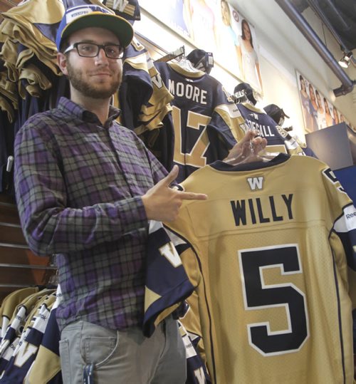 Winnipeg Blue Bomber QB Drew Willy #5 jerseys are the big seller at the Bomber Store at Investors Group Field Friday the day after the season opener victory over Toronto. Season ticket holder Bryce Twerdochlib purchases one.   Paul Wicek story Wayne Glowacki / Winnipeg Free Press June 27 2014