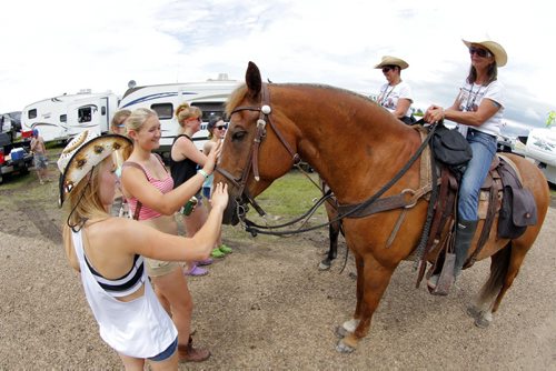DAUPHIN'S COUNTRYFEST - Friday afternoon party in the campground. Some Countryfesters get introduced to Jeanie VanWorkum and her horse named Mister. They horse crew was brought in to promote good citizenship in the campground.  BORIS MINKEVICH / WINNIPEG FREE PRESS  June 27, 2014