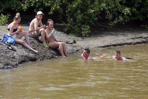 DAUPHIN'S COUNTRYFEST - Friday afternoon party in the campground. In the back area some Countryfesters cool off in the creek. BORIS MINKEVICH / WINNIPEG FREE PRESS  June 27, 2014