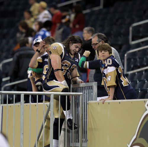 Not waiting for the gates to open and allow fans on the field, Michel-Pierre Pontbriand goes over the game with his peeps after the Blue Bombers defeated the Argonauts Thursday night at Investors Field. See story. June 26, 2014 (Phil Hossack / Winnipeg Free Press)