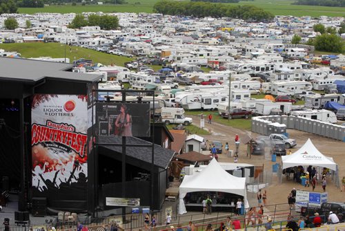 DAUPHIN'S COUNTRYFEST - Campers fill the fields behind the stage. The festival expanded it's camping area to 4300 this year. BORIS MINKEVICH / WINNIPEG FREE PRESS  June 27, 2014